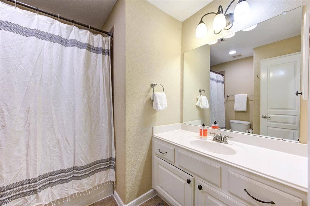 The well-maintained third bathroom upstairs offers a functional and clean design, featuring a tub/shower combo, a vanity with ample counter space, and modern finishes. It’s conveniently located near the secondary bedrooms, making it perfect for family members or guests.