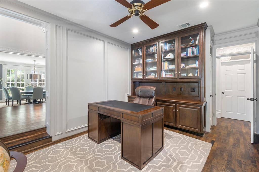 Step down into a refined office space featuring rich built-ins, perfect for both productivity and style.