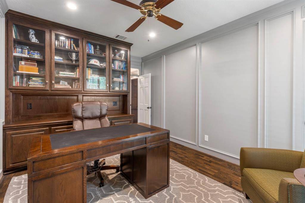 Picture frame molding adds timeless charm, making this home office both inviting and sophisticated.