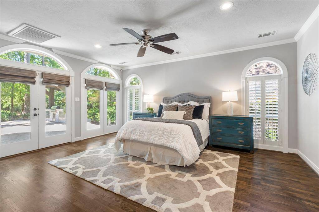 Wake up to stunning views—this primary bedroom overlooks the sparkling pool and lush golf course, offering resort-style tranquility every day.