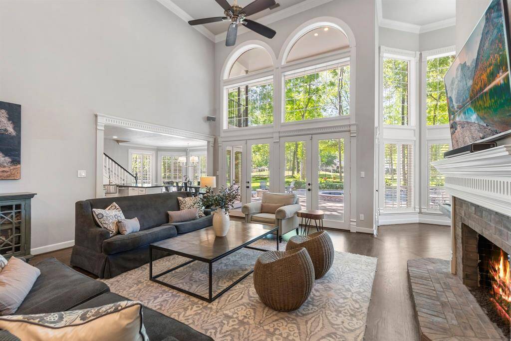 Relax in the living room, which offers stunning views of both the pool area and the golf course, blending indoor comfort with outdoor beauty.