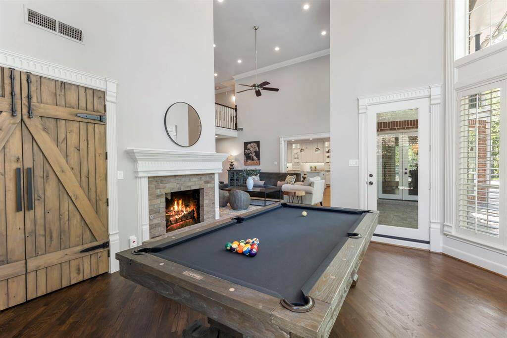 Expansive den with a closet for games/storage, seamlessly open to the living room, patio, pool, and backyard—perfect for entertaining.