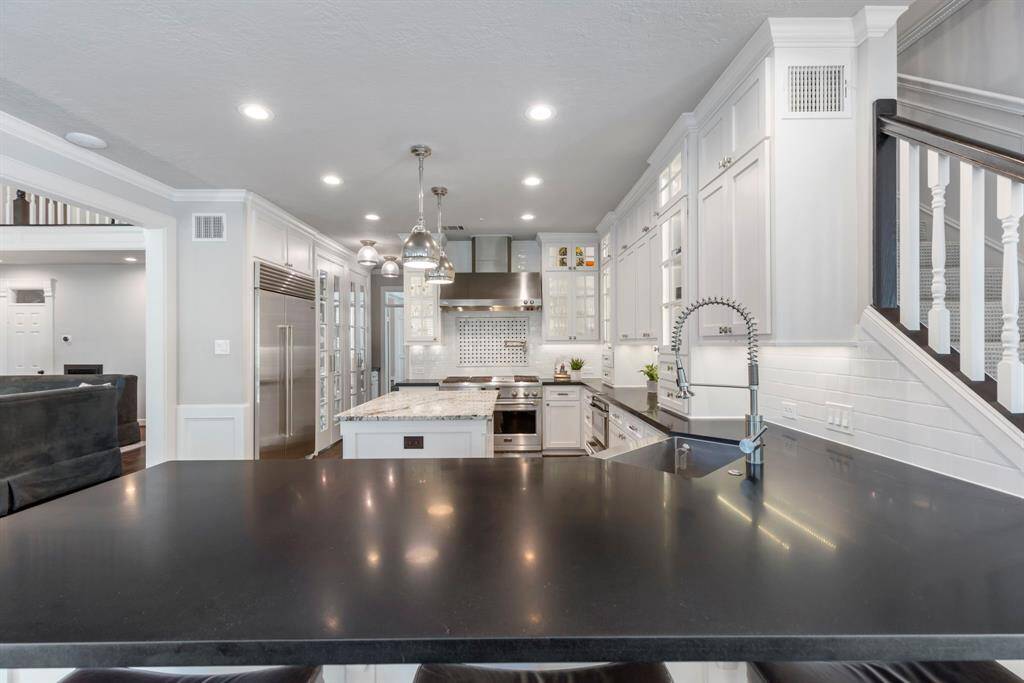 Another look at the beautiful kitchen, boasting elegant granite countertops and updated fixtures.