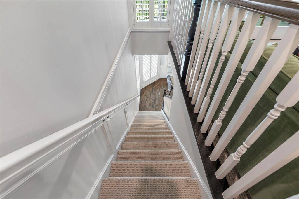Convenient second back staircase offering easy access between levels, enhancing both functionality and flow in the home.