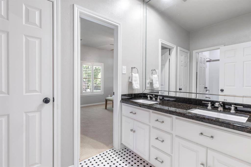 Updated Jack and Jill bath featuring modern fixtures and thoughtful design, ensuring convenience and style.