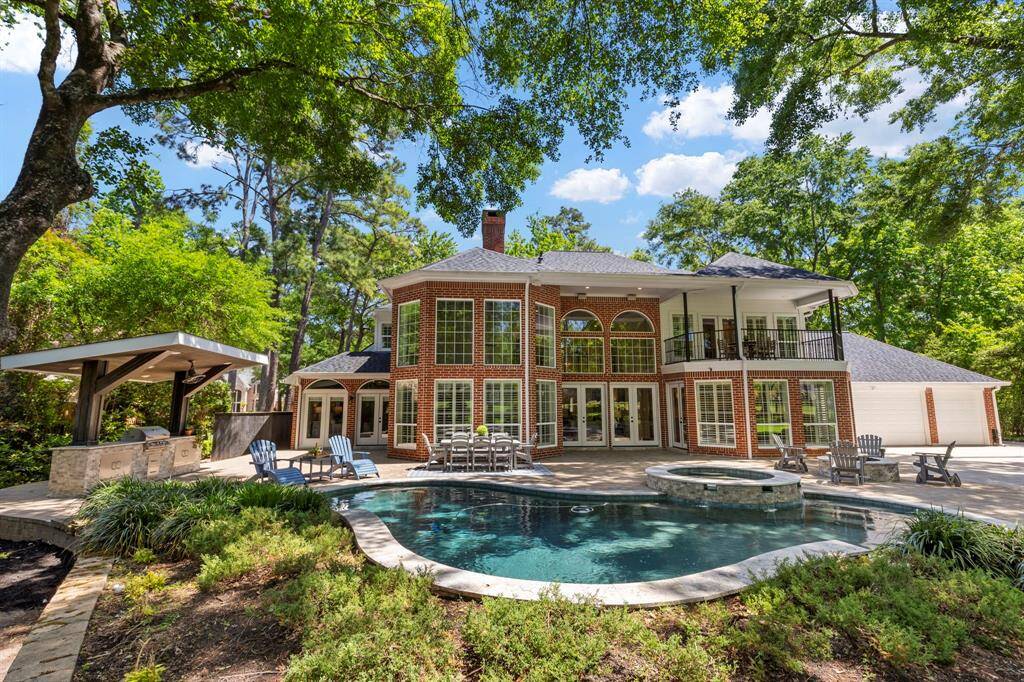 View from the backyard showcasing the inviting pool and patio area, perfect for relaxation and outdoor entertainment.
