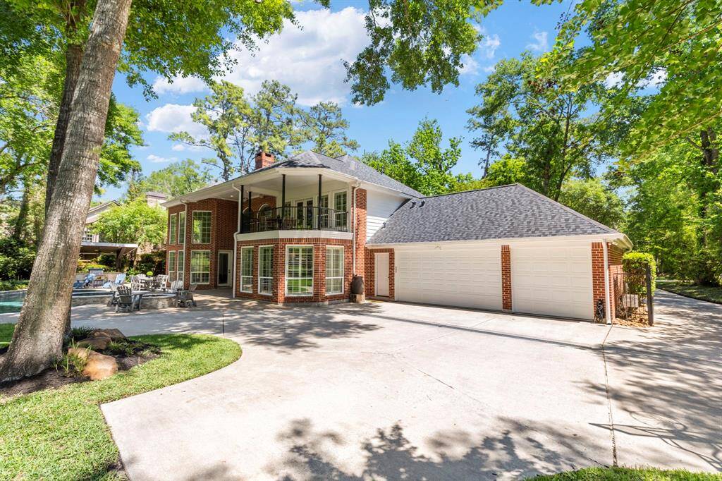 Gated driveway leading to a spacious 3-car garage, ensuring privacy and ample parking space.