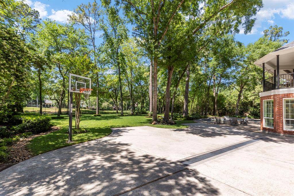 Oversized driveway with extra parking space and a built-in basketball hoop, ideal for recreation and convenience.