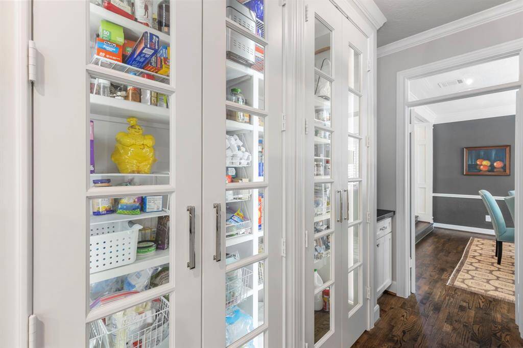 Discover the expansive pantry, beautifully illuminated with glass doors, offering both style and ample storage space.