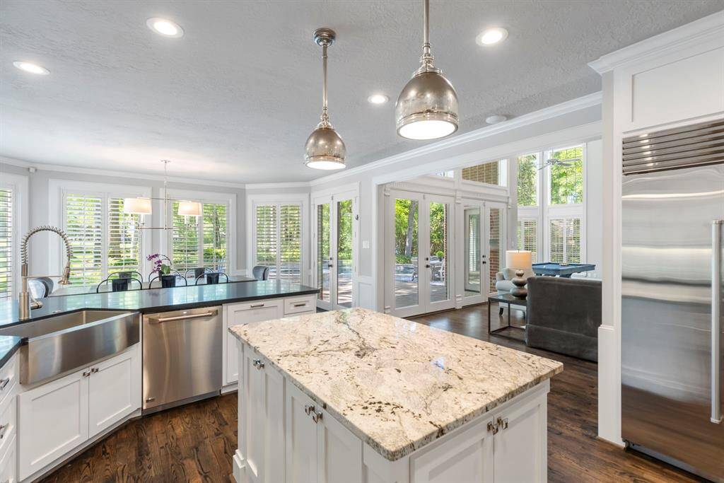 Delight in the kitchen's eat-up bar, seamlessly flowing into the breakfast area, with picturesque views of the backyard and golf course.