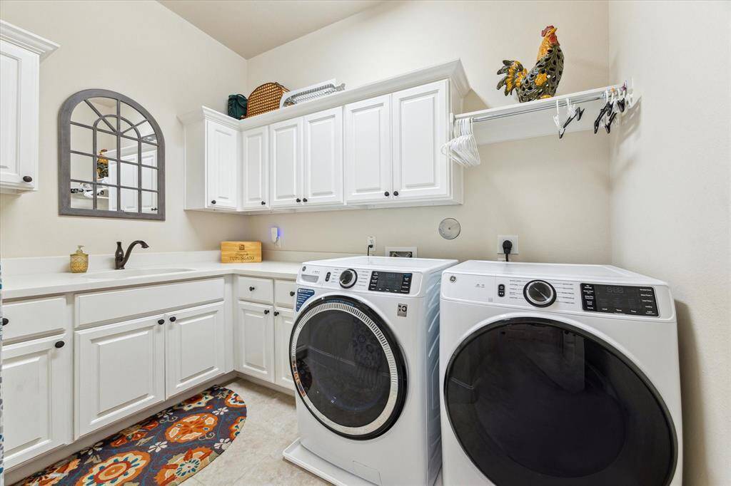Laundry room is complete with a folding counter and sink!