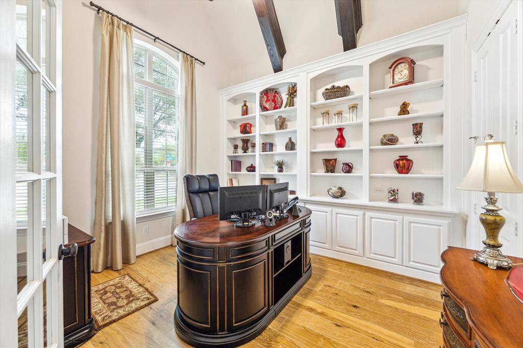 Spacious study with cathedral ceiling, built in shelves and cabinets!