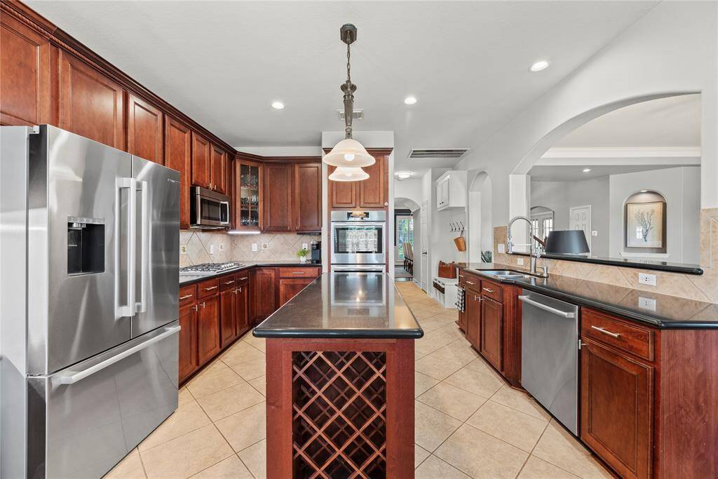 The sprawling center island serves as a versatile centerpiece, providing additional workspace and storage.
