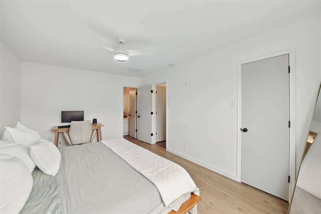 ANOTHER VIEW OF THE PRIMARY SUITE WITH DOOR THROUGH TO THE PRIVATE ENSUITE BATHROOM.