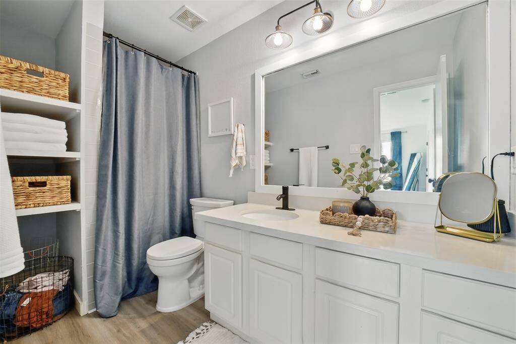 THE ENSUITE BATHROOM WAS UPDATED AND MODERNIZED IN 2020. LOOK AT ALL THAT STORAGE SPACE! THE BATHROOM HAS A WALK-IN SHOWER.