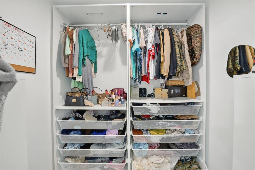 SPACIOUS WALK-IN CLOSET WITH RAILS AND SHELVES FOR EASY ORGANIZING.