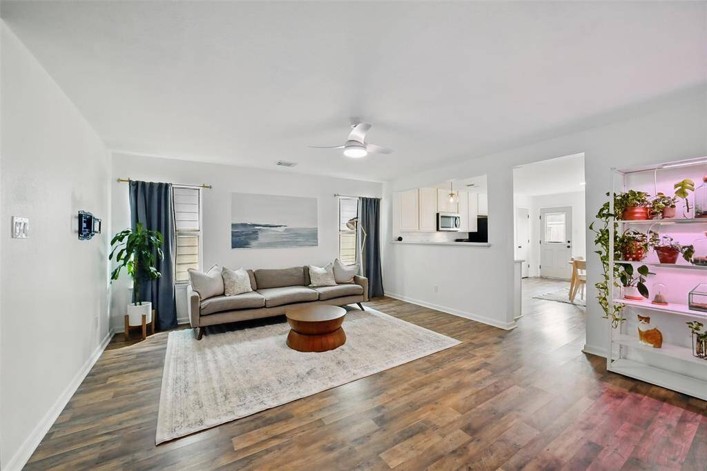 THE FAMILY ROOM FEATURES MODERN CEILING FAN AND BREAKFAST BAR. THE FAMILY ROOM OPENS UP TO THE KITCHEN. PERFECT FOR ENTERTAINING.