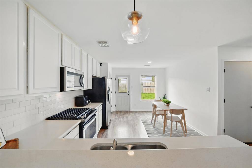 ENJOY COOKING ON YOUR GAS RANGE. THE BACKDOOR LEADS TO THE PATIO.