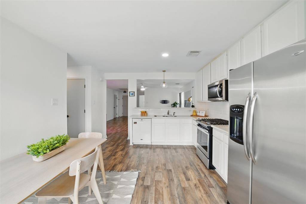 ANOTHER VIEW OF THE KITCHEN/DINING AREA. BONUS THE REFRIGERATOR STAYS!!
