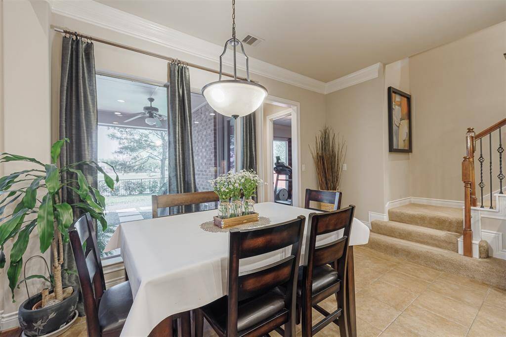 Breakfast room located off the kitchen. Second staircase shown to the right.