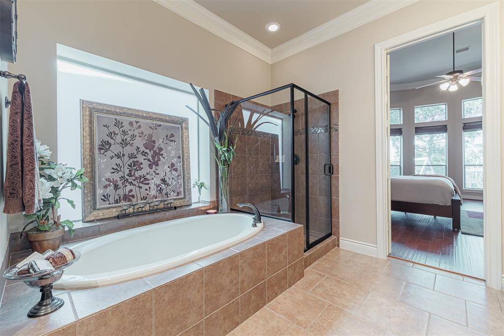 Primary suite also features a large soaking tub with separate walk-in shower.