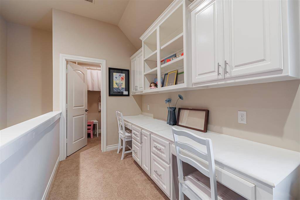 Built-in desk area with closet located upstairs.