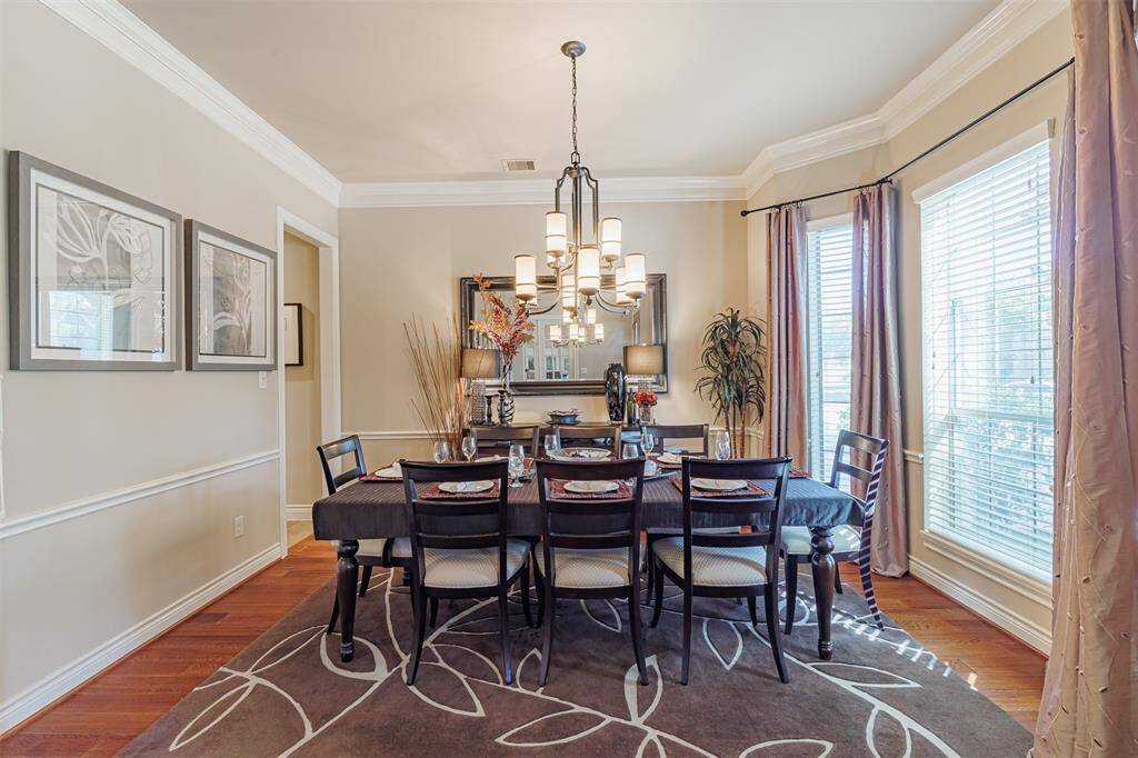 The formal dining room features wood flooring, crown molding and the butler’s pantry offers elegant functionality.