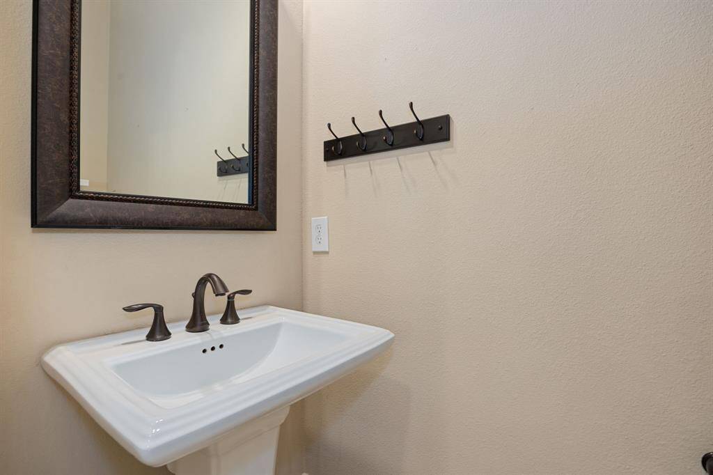 This charming half bath combines style and convenience with its elegant fixtures and tasteful finishes. Perfect for guests, it features modern lighting and a well-designed layout that maximizes space, creating a comfortable and inviting atmosphere.