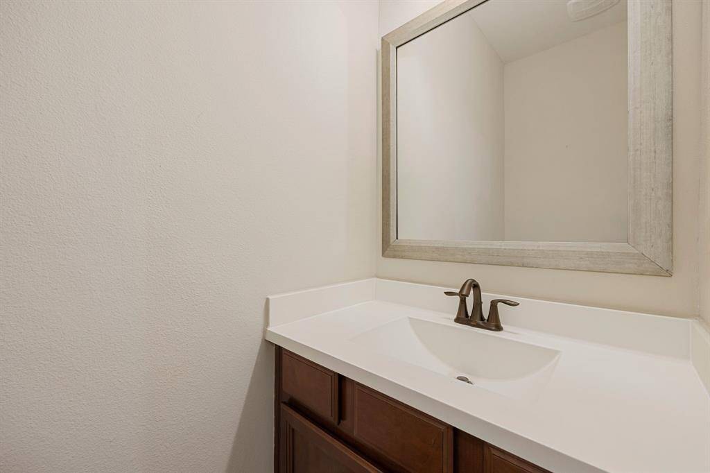 This conveniently located upstairs half bath, just off the gameroom, is perfect for guests and family alike. Featuring a modern elegant fixtures, and tasteful finishes, it adds both style and functionality to the entertainment space.