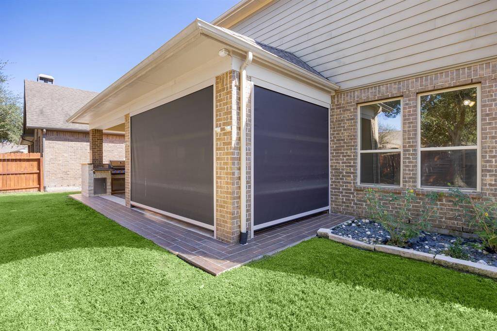 Enjoy year-round comfort on this spacious patio equipped with retractable sunshades, providing the perfect balance of sunlight and shade. The sunshades add privacy and help keep the area cool, making it an inviting retreat in any season.