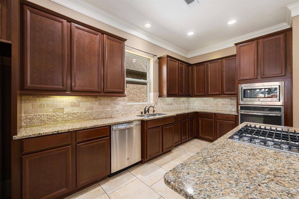 Any chef's dream, this stunning kitchen is perfect for everyday life as well as entertaining family and friends! Extra large kitchen island is perfect for conversation or that much needed space to lay out your party spread for everyone to enjoy! Large windows provide lovely views and plenty of natural lighting throughout the day.