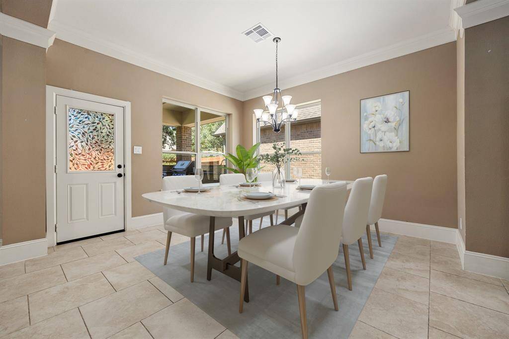You and your guests will certainly dine in style in this amazing dining room! Featuring a gorgeous modern chandelier, large windows, neutral paint, high ceilings, crown molding and tile flooring. Perfect space to entertain family and friends.