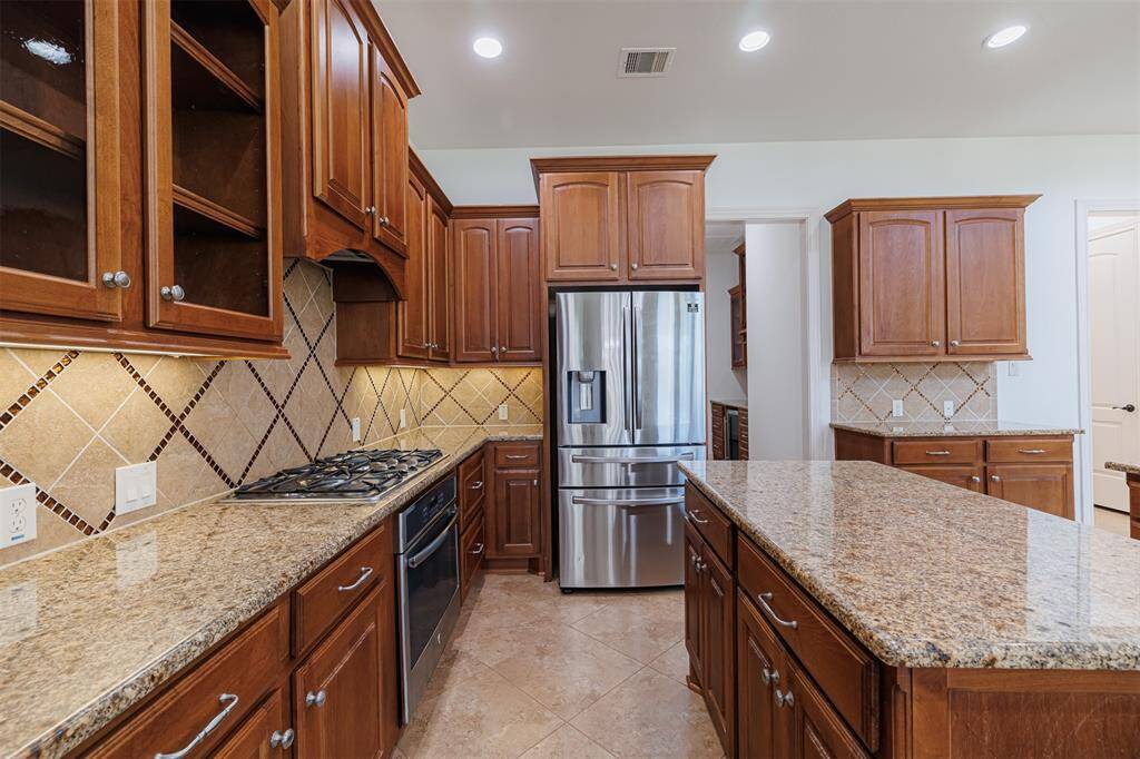 Kitchen also features gas cooking, stainless steel appliances and under cabinet lighting.
