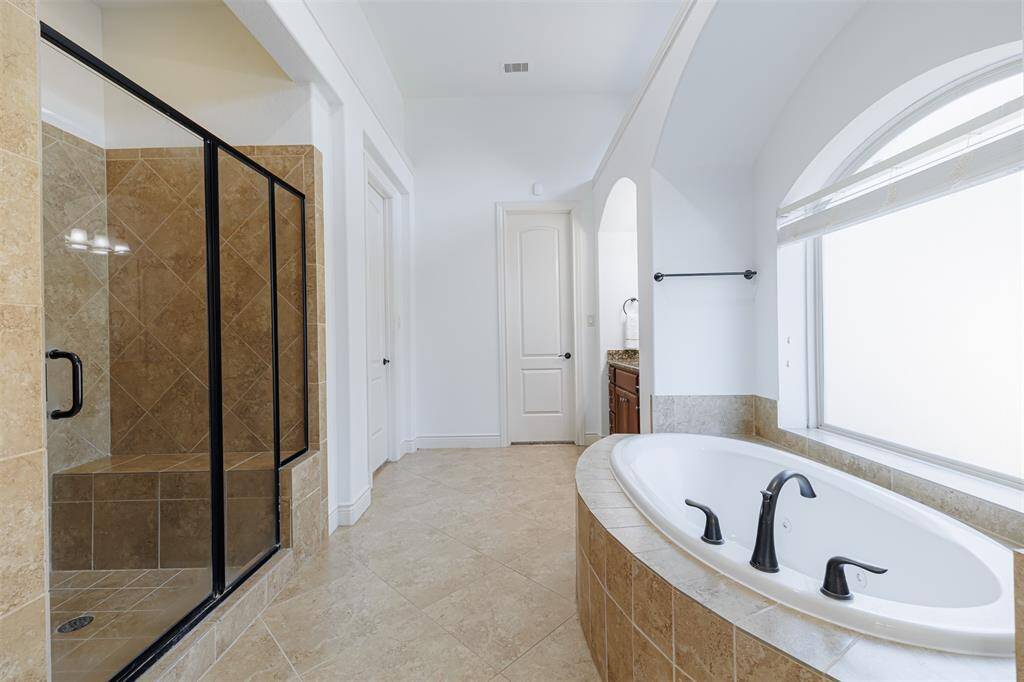 The primary bath also features a jetted tub and large separate walk-in shower.