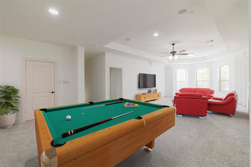 Picture is Virtually Staged. Large game room upstairs with large walk-in storage closet.
