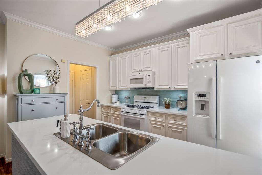 Elegant white kitchen featuring a vibrant backsplash for a stylish touch.