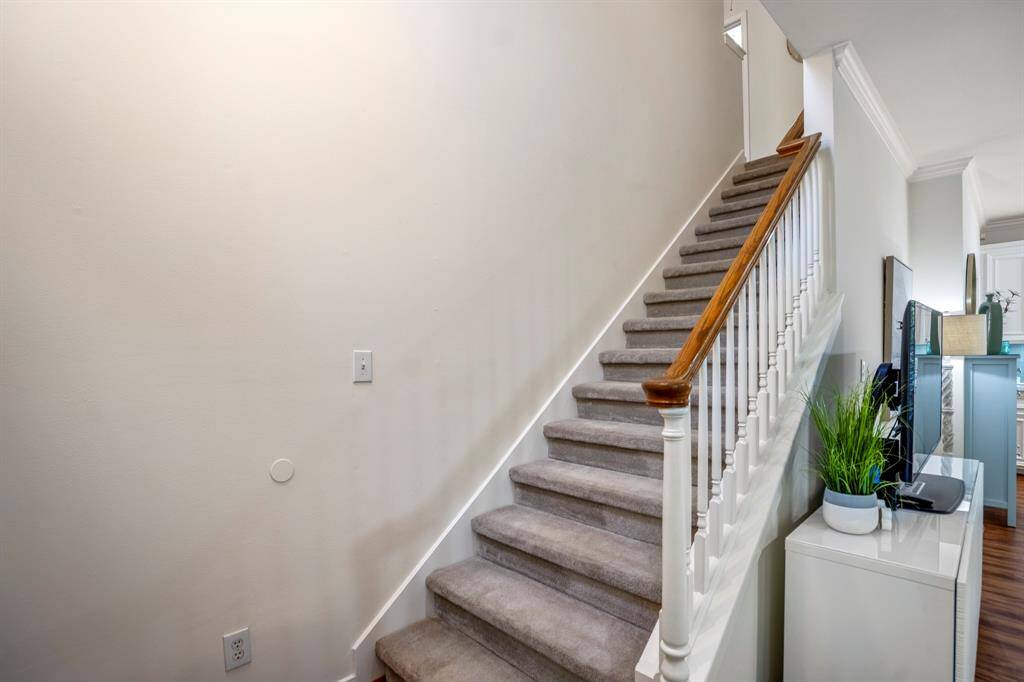 Stairs leading to the upper level with the bedrooms.