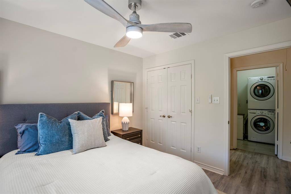The room has a fresh, bright ambiance with light wood flooring.
