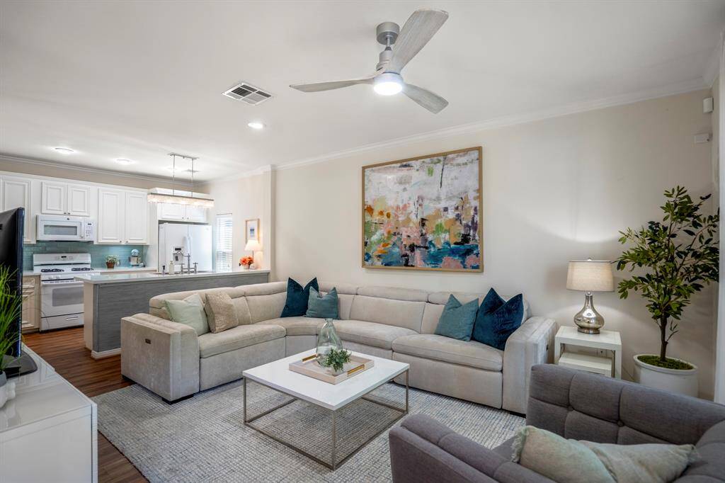The main floor features an inviting living room and a modern kitchen, perfect for comfortable living and entertaining.