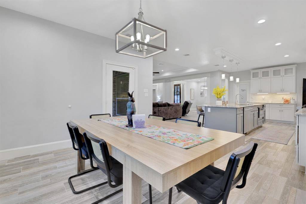 Enjoy serene views of the outdoors from the breakfast area, perfectly situated within the open and airy floor plan