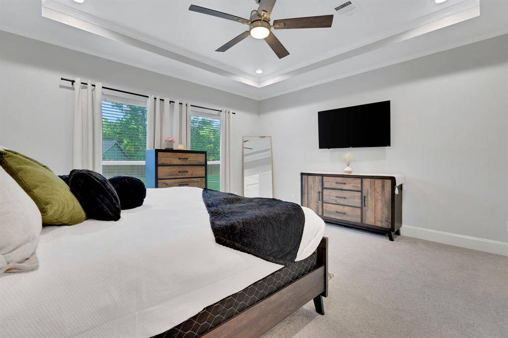 With soaring tray ceilings and gorgeous backyard views, the primary bedroom offers a relaxing retreat complete with a private en suite.