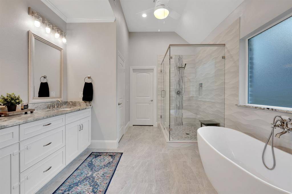 Elegant dual sinks provide both function and style in the beautifully designed primary bath.