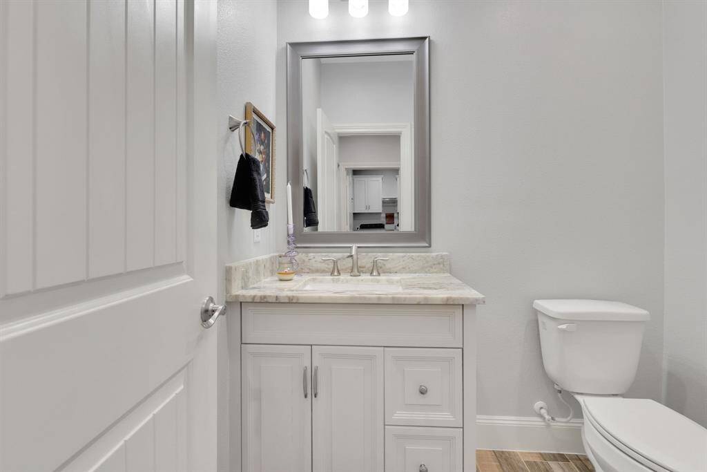 A conveniently located half bath sits just off the oversized garage—perfect for guests or quick clean-ups after a busy day.