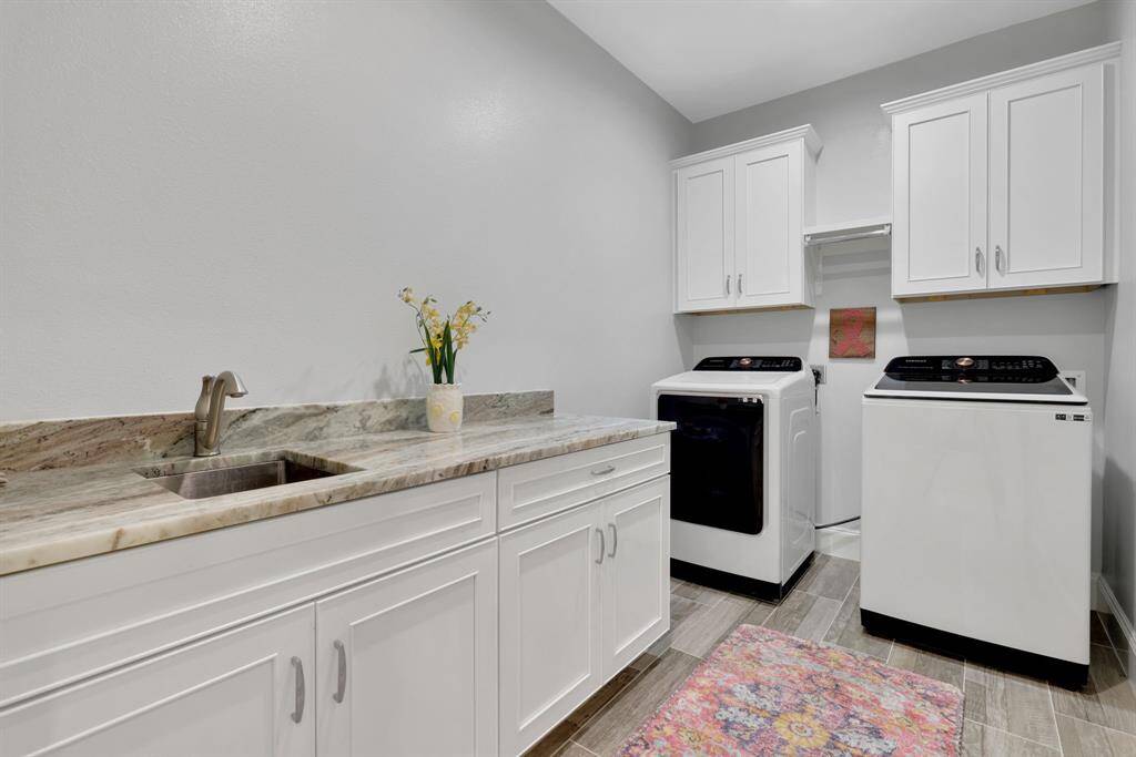 Spacious laundry with sink and folding area.