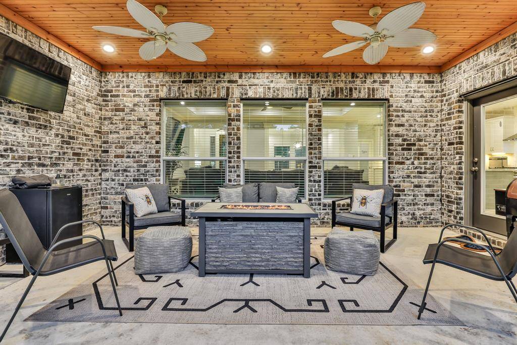 Style and Elegance shine on this single-story brick home with a spacious driveway and two-car garage. Nestled among mature trees and a lush lawn, it offers a private, serene setting. Enjoy a warm, inviting atmosphere with large windows and tasteful exterior lighting.