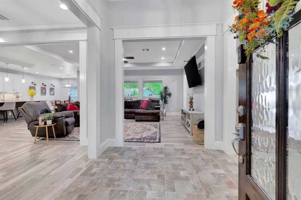 A captivating layout offering a seamless flow from the inviting entryway to the spacious living area, designer kitchen, and versatile flex space.
