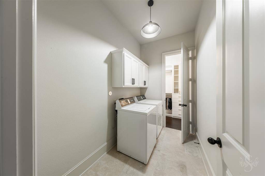 Laundry room with access to the primary walk-in closet.