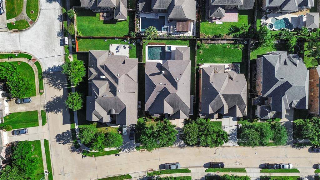 Additional highlights include a water softener, reverse osmosis water filter at the kitchen sink, epoxy-coated garage floors, eave lighting, and plantation shutters throughout.