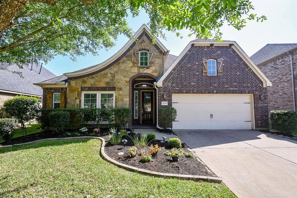This charming home features a beautiful combination of stone and brick exterior, a well-maintained front yard with manicured landscaping, and a two-car garage on a cu-de-sac. Its inviting entrance and classic design make it an attractive option for potential buyers.