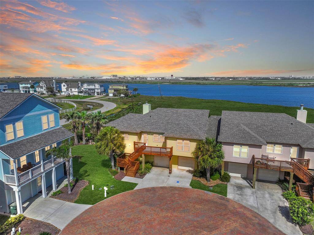 Welcome to 2807 Izamal Court! This better-than-new islander home in Galveston's small & secluded Campeche Shores community is a bird water's paradise, nestled between the marshy banks of Sydnor Bayou and the immaculate grounds of the Moody Gardens Golf Course.